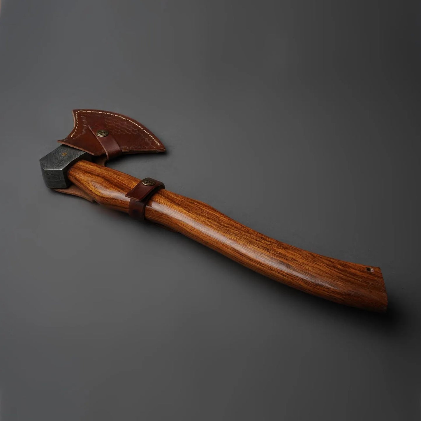 Wooden tool with leather handle on a gray background