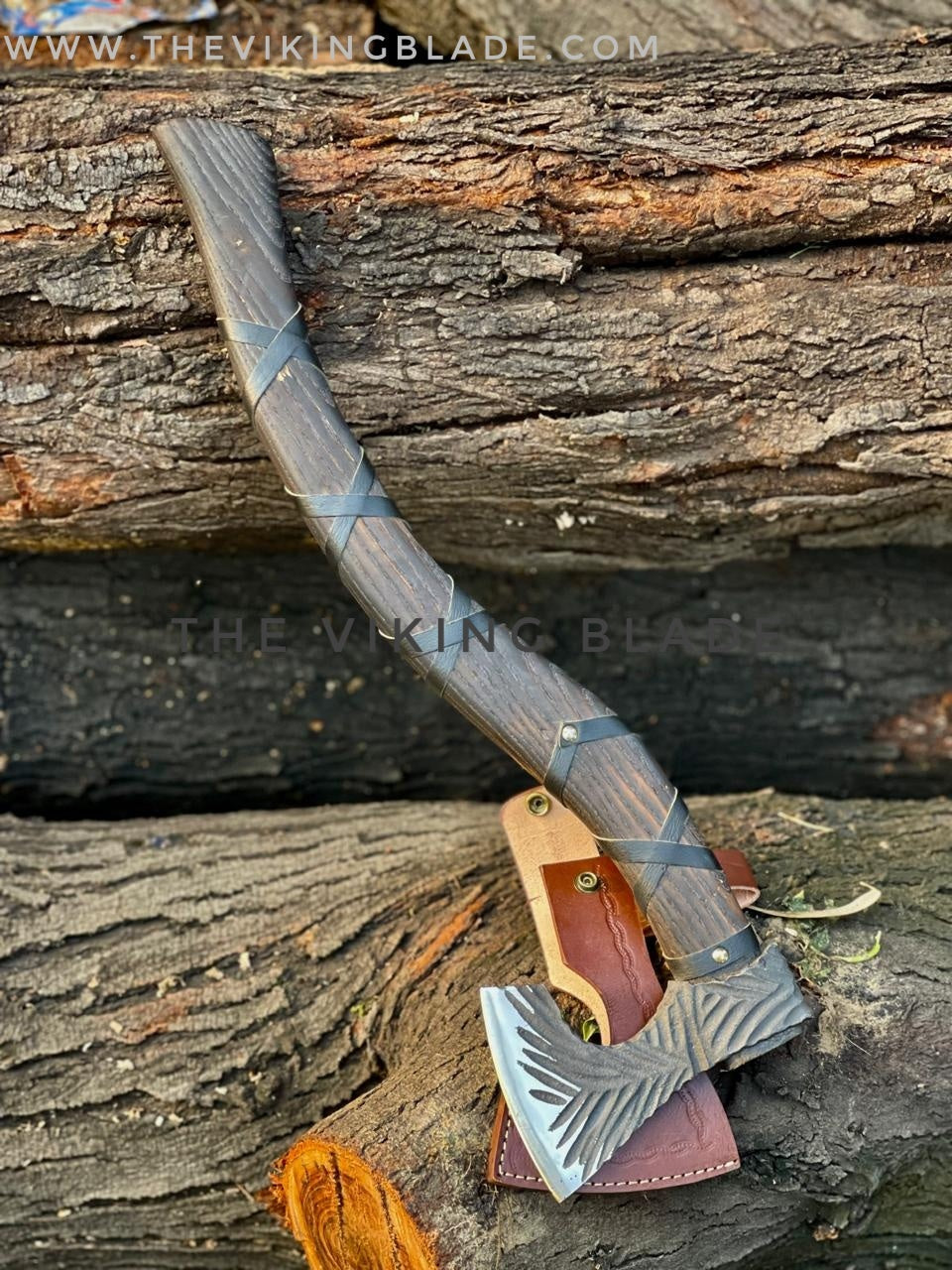 Viking-style axe with leather sheath on wooden background