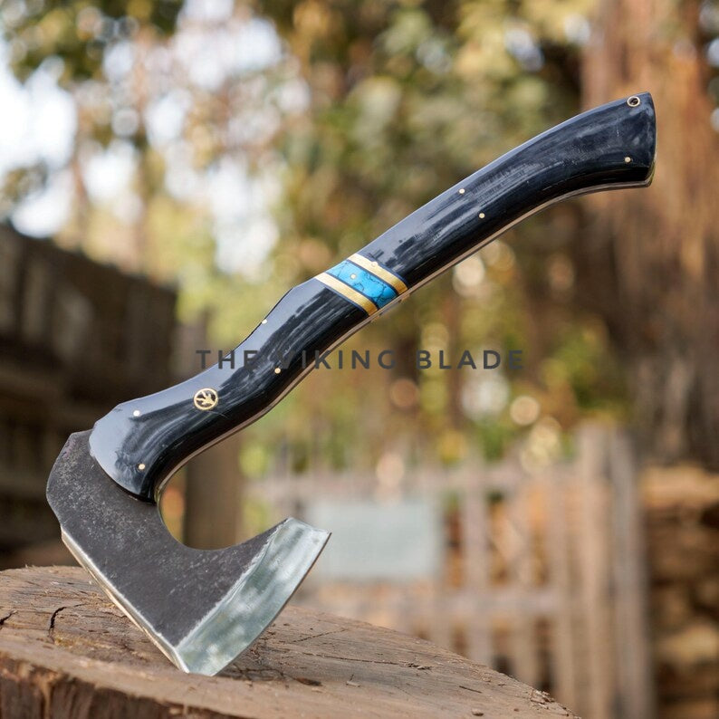 Axes on a wooden stump with a blurred natural background