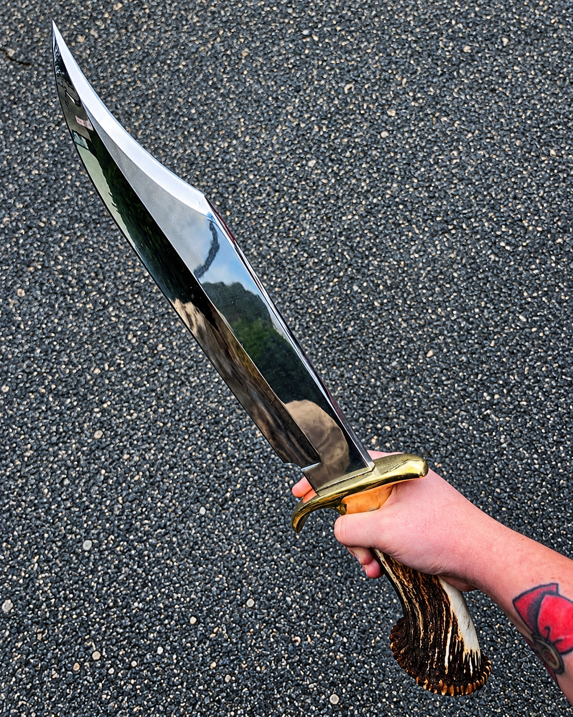 Hand-Forged Antler Handle Bowie Knife
- Overall Length: 18 inches
- Blade: Razor-sharp, hand-forged blade
- Handle: Genuine antler handle
- Sheath: Includes handcrafted leather sheath
- Finish: Handmade with attention to detail
Care & Tips:
Keep the blade clean and dry after use. Apply a light coat of knife oil regularly to help protect the steel from moisture and rust. Store the knife in a dry place and avoid leaving it wet or damp inside the sheath.