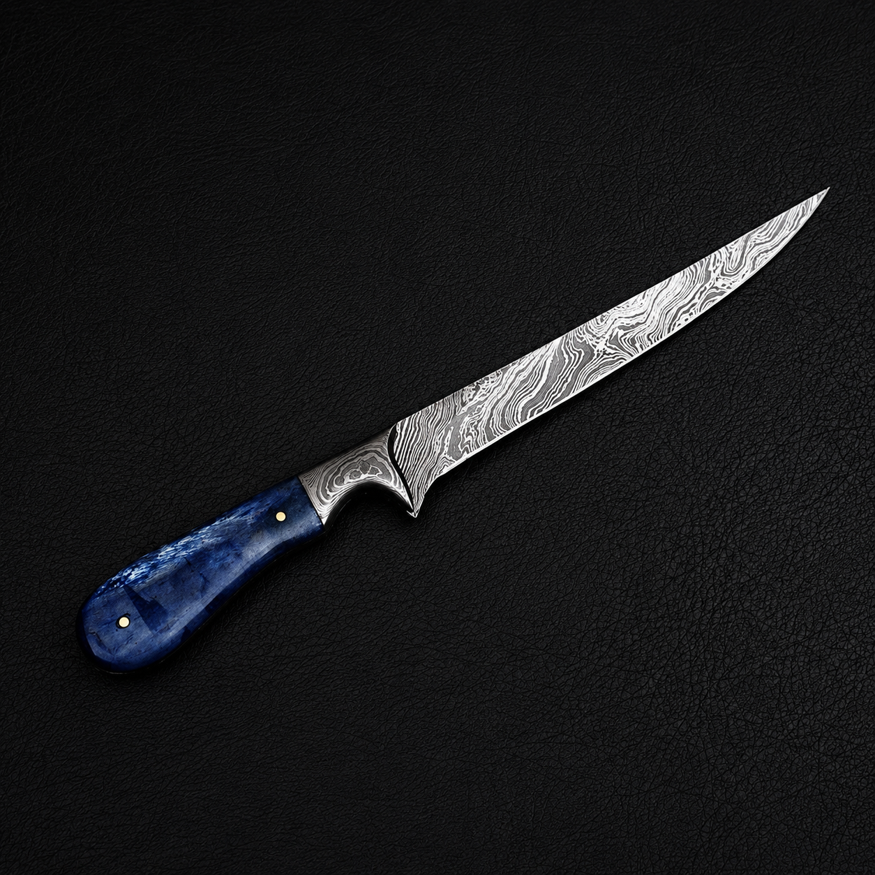A Damascus steel kitchen knife with a patterned silver blade and a textured blue handle, displayed diagonally on a dark textured background.