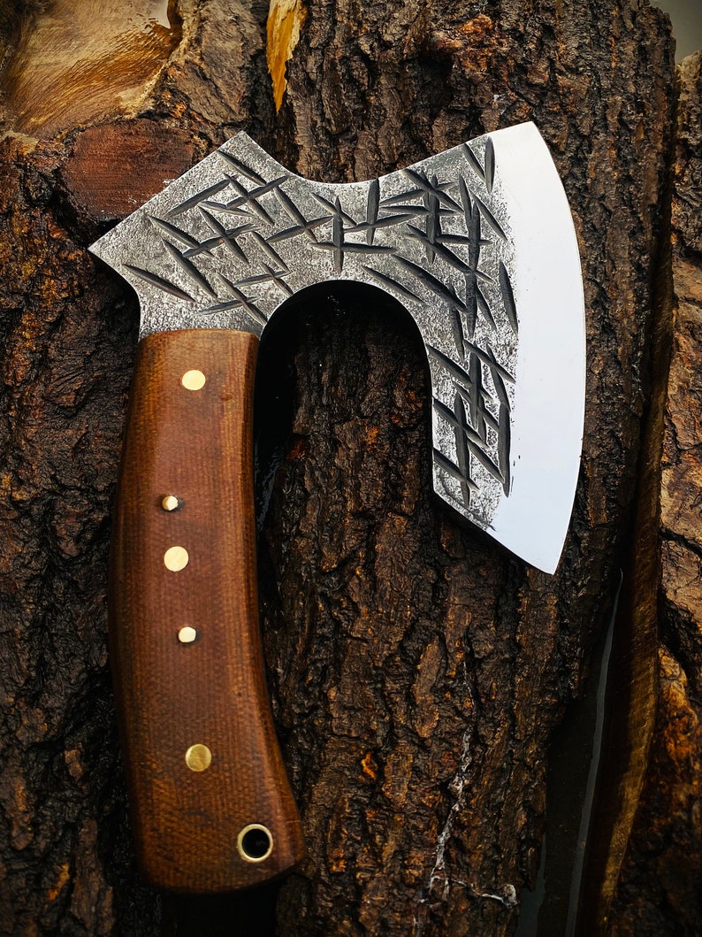 Decorative axe with a wooden handle on a tree stump