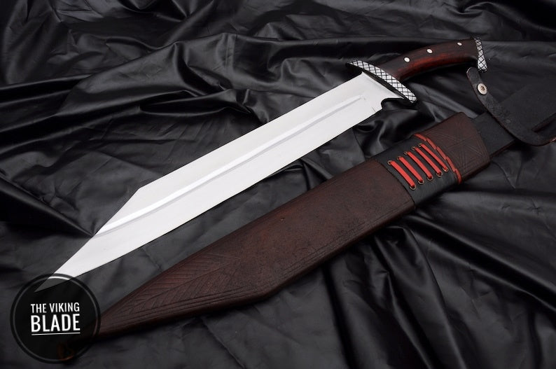 An 18-inch handmade Nordic seax with a polished blade and a brown, full-tang rosewood handle featuring a black leather scabbard.