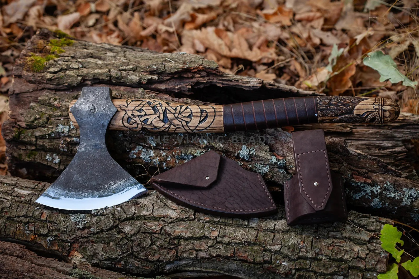 Decorative axe with leather sheath on a wooden log