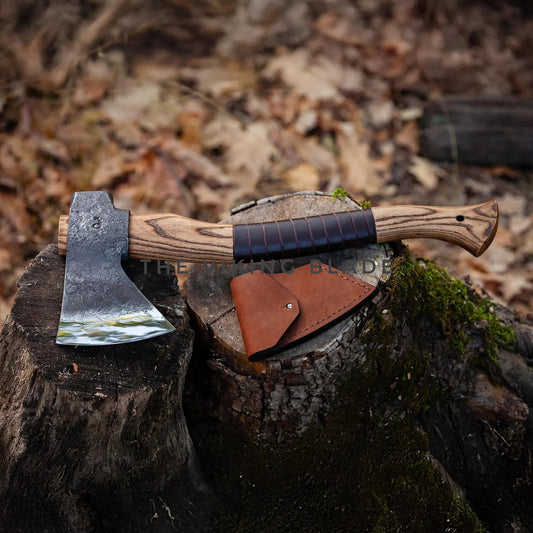 Axes with leather sheathes on a wooden stump in a forest setting
