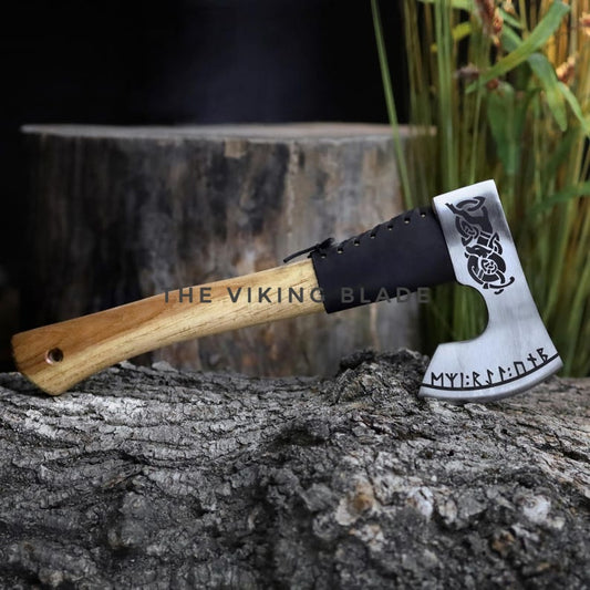 Axes with wooden handle and metal heads on a tree stump