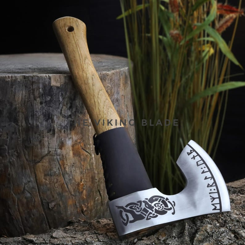 Viking-style axe with decorative blade on a wooden stump