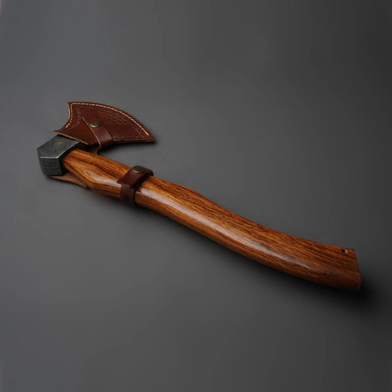 Wooden tool with leather handle on a gray background