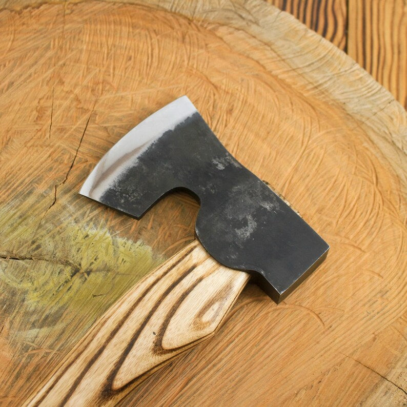 Wooden axe handle on a wooden surface