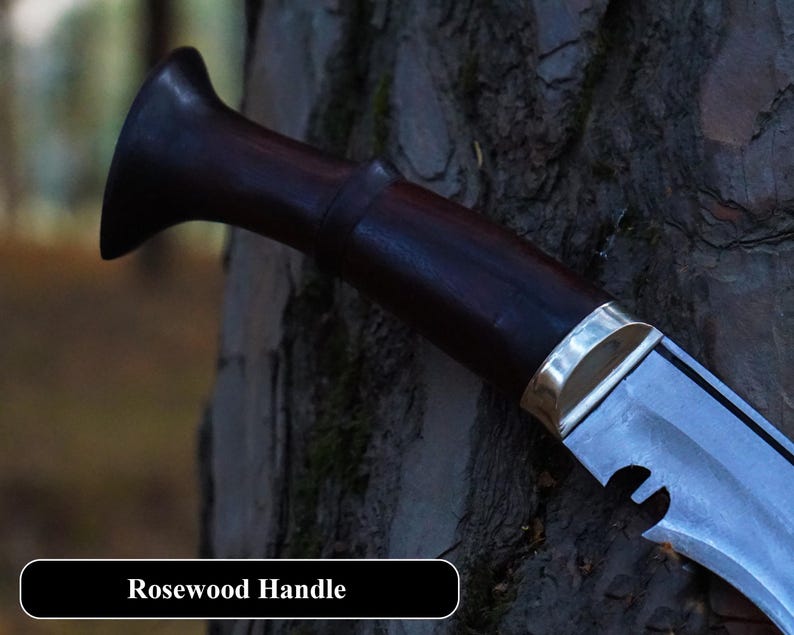 Knife with rosewood handle against a tree trunk