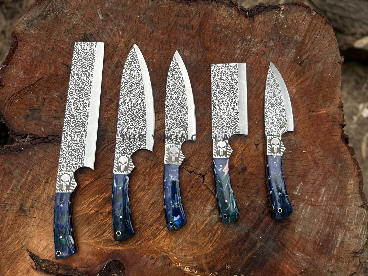 Five knives with decorative patterns on a wooden surface