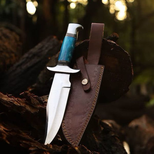Knife with a blue handle in a brown leather sheath on a wooden surface