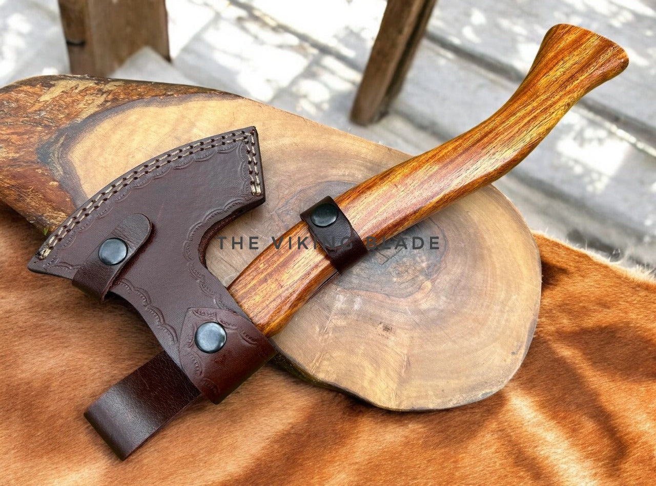 Wooden axe with leather sheath on a wooden block