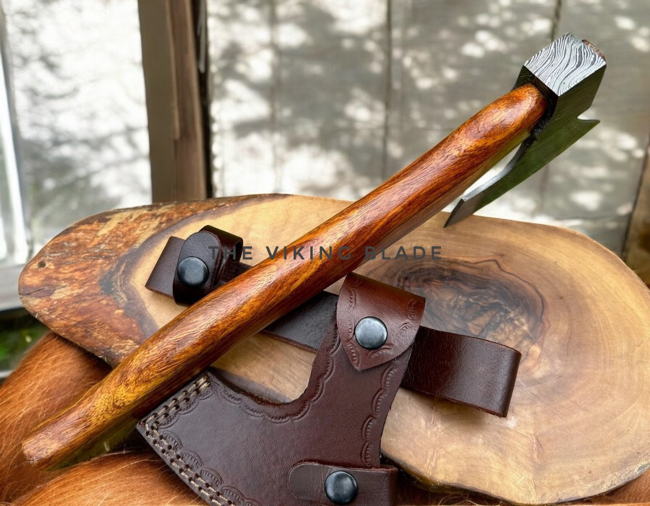 Wooden tool with leather sheath on a wooden surface