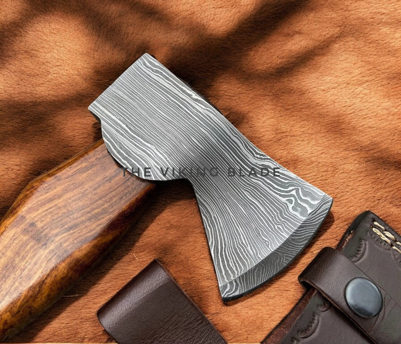 Wooden-handled axe with a silver blade on a wooden surface