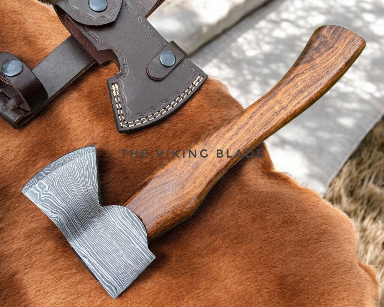 Wooden-handled axe with a leather sheath on a brown surface