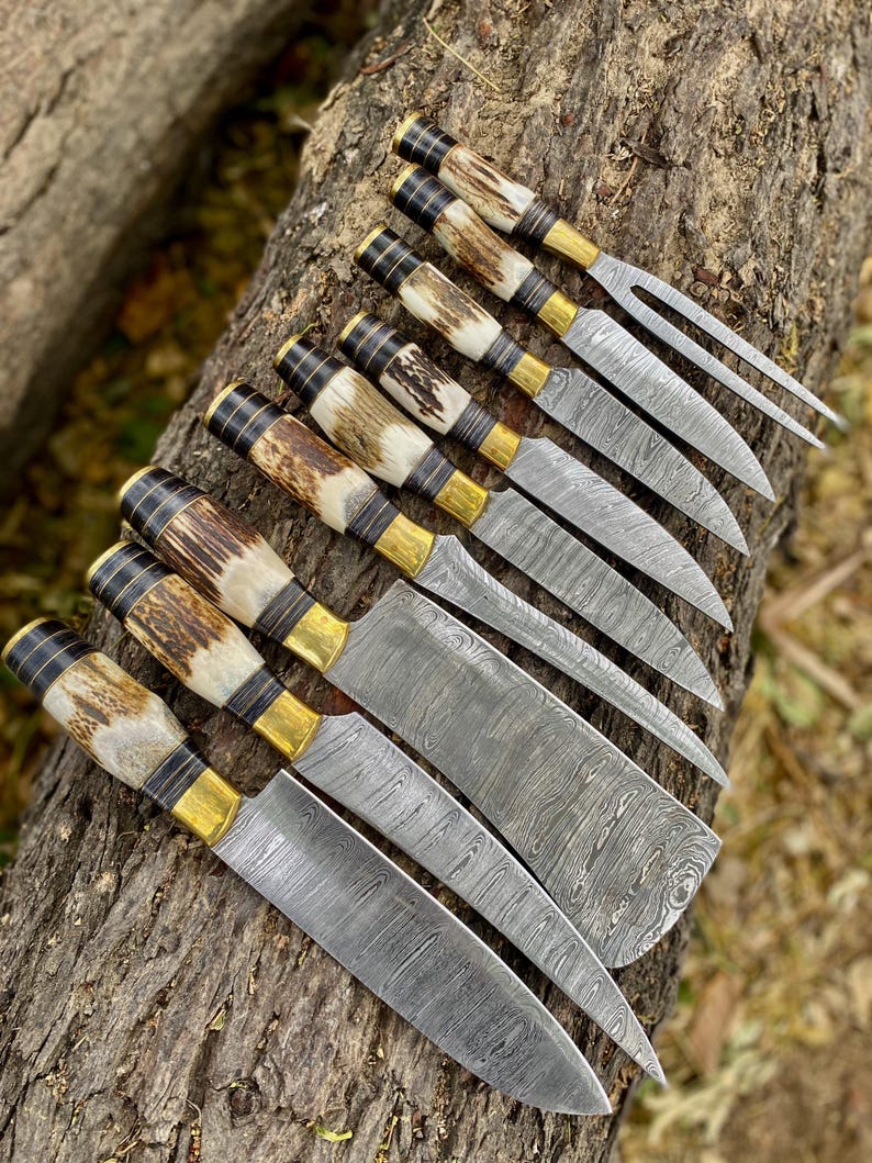 Set of knives with decorative handles on a tree trunk