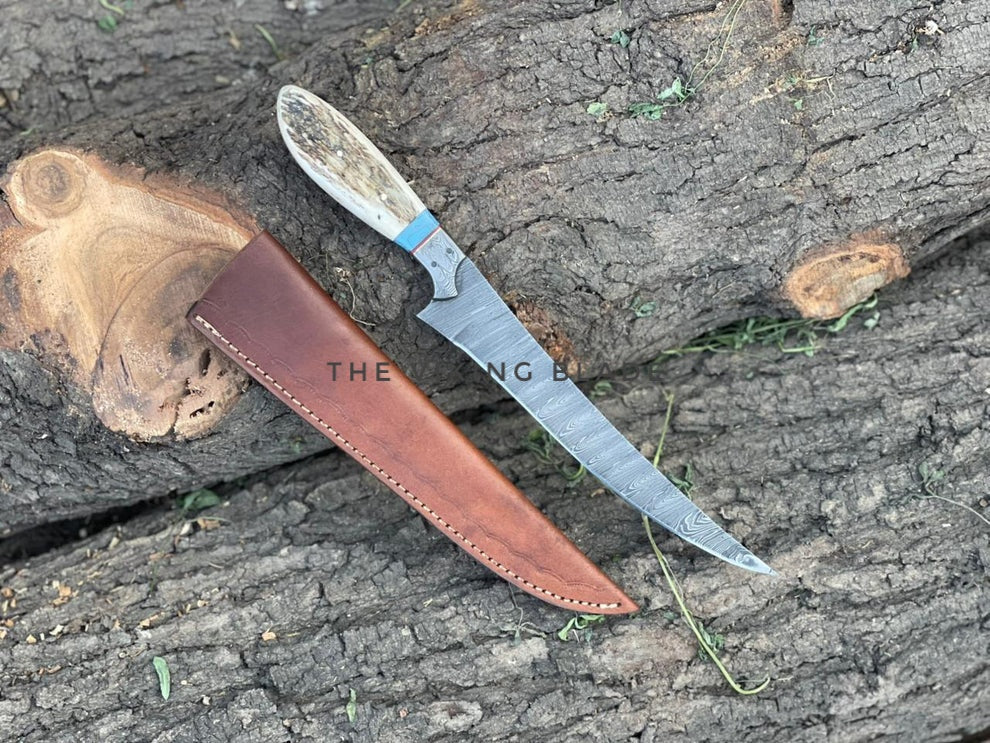 Knife with a leather sheath on a wooden surface