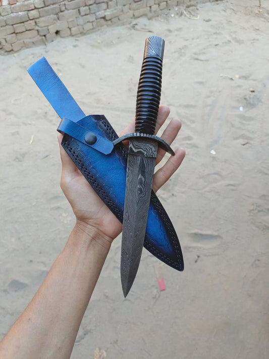 Hand holding a knife with a blue sheath against a textured wall background