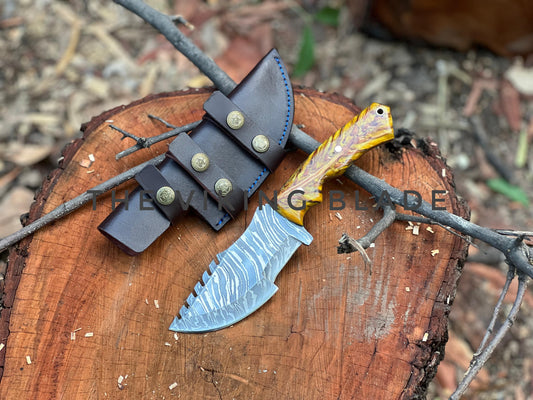 Knife with a sheath on a wooden stump with blurred background