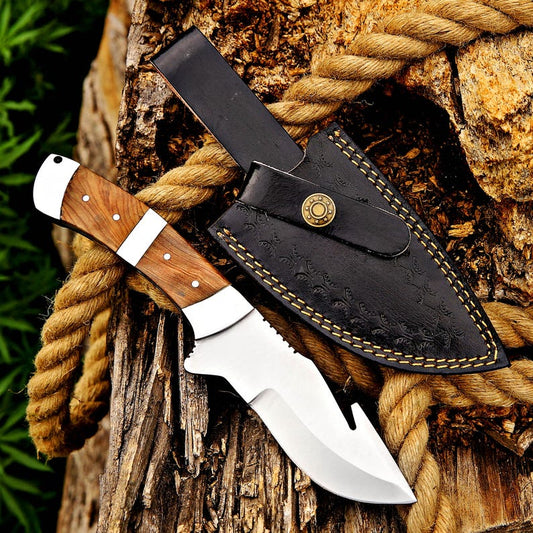 Knife with wooden handle and leather sheath on a wooden surface with rope