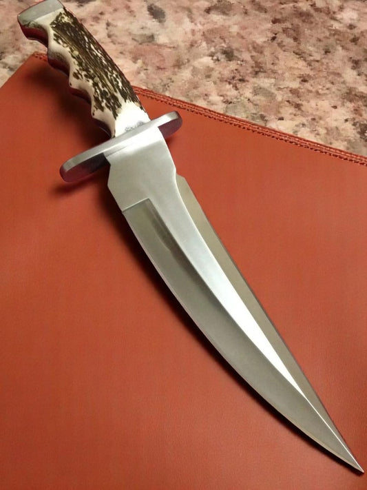 Knife with staghorn handle on a brown surface