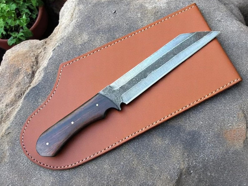 Knife with leather sheath on stone background