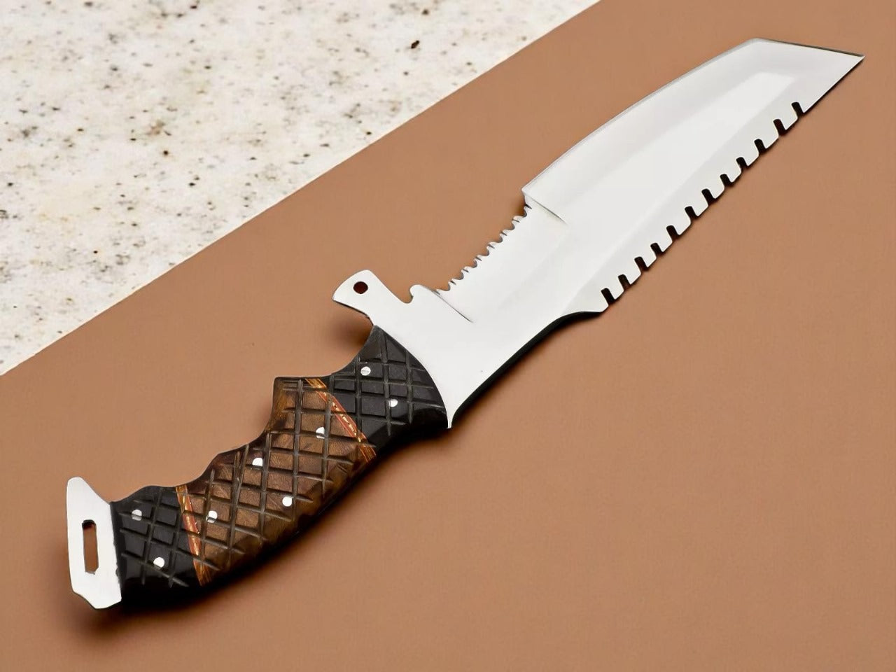 A custom handmade hunting Tanto knife with a serrated edge and a wooden handle with bull horn bolsters, placed on a beige background.