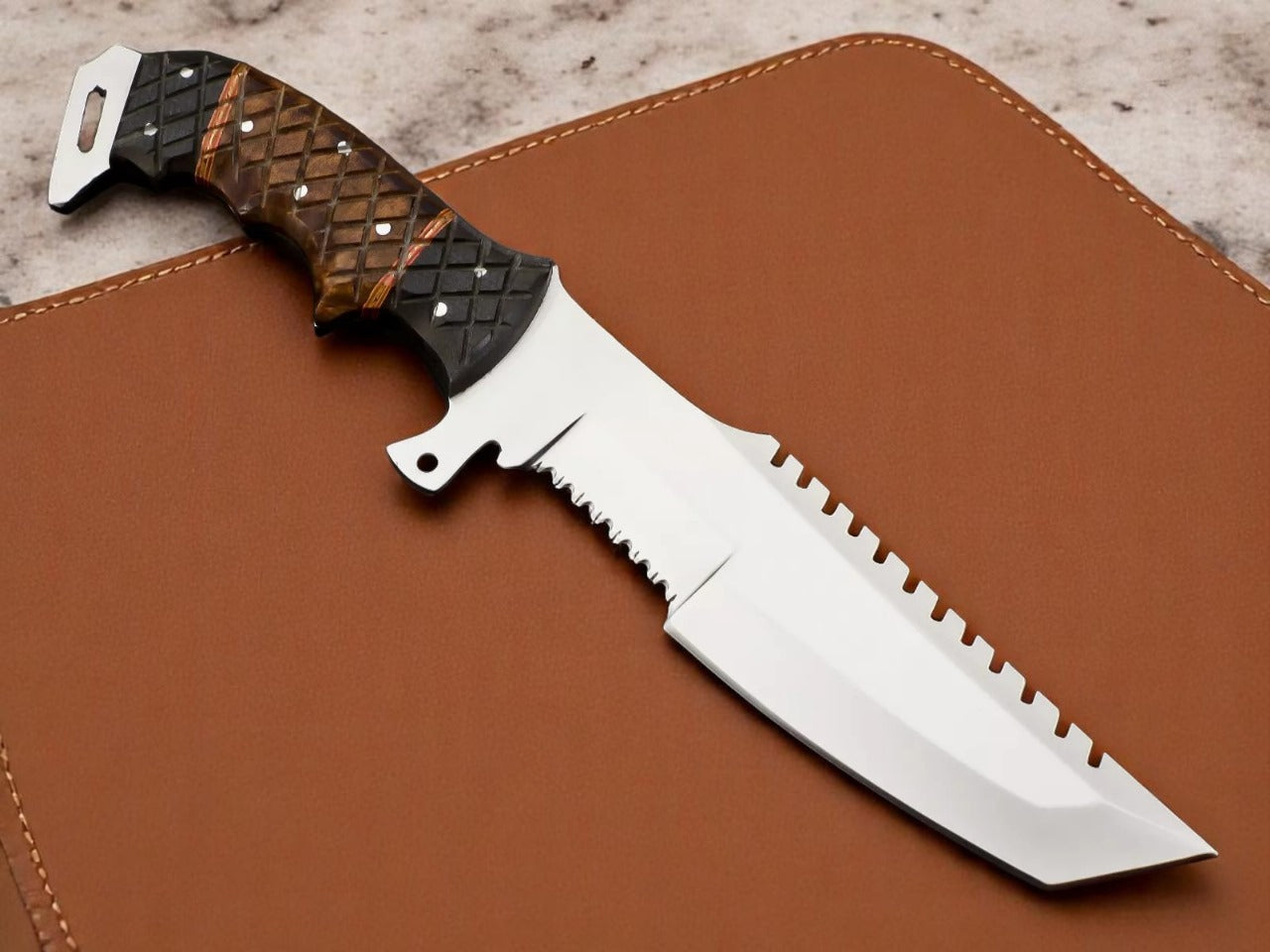 Knife with a textured handle on brown leather background