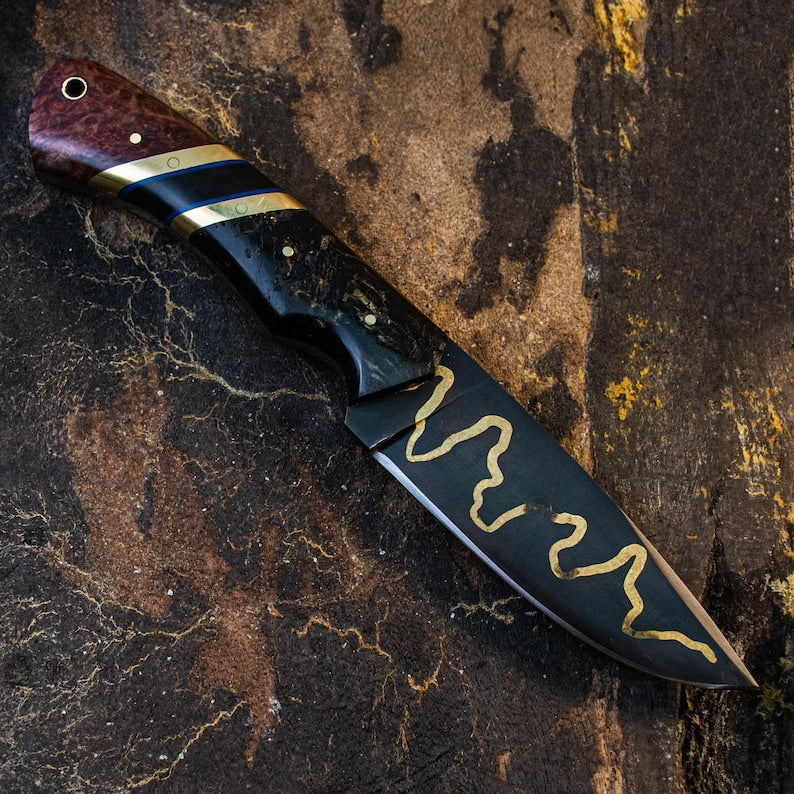 Knife with decorative handle and blade on a textured background