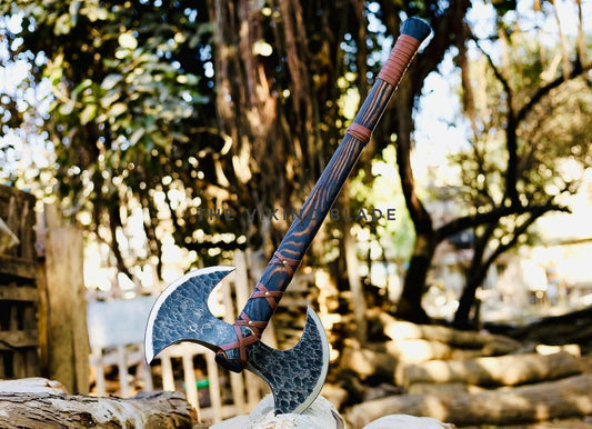 Decorative axe with a wooden handle against a natural background
