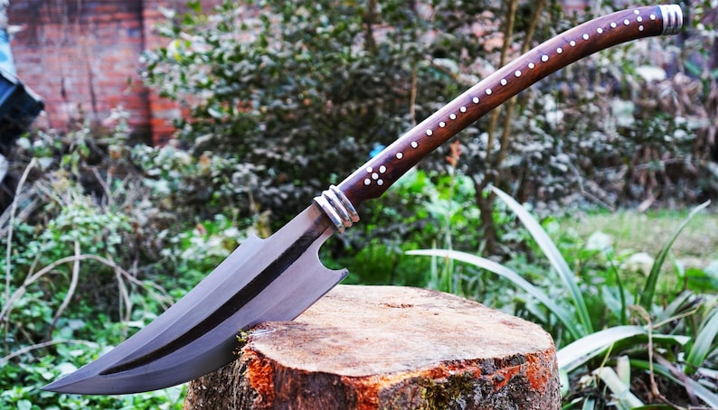Decorative sword on a wooden stump with a natural background