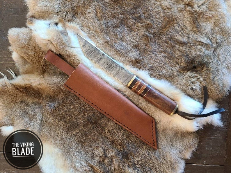 Custom forged Damascus Seax knife with elegant walnut handle and premium leather sheath.
