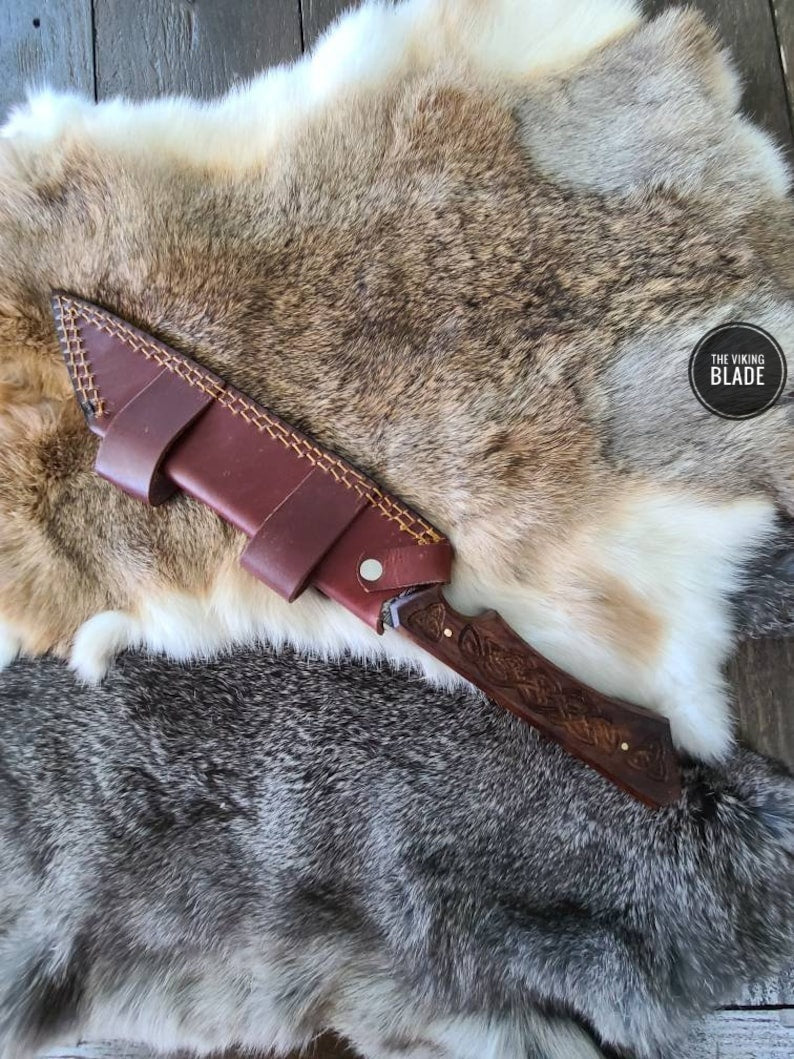 Premium Damascus Seax knife with patterned blade and handcrafted leather sheath.