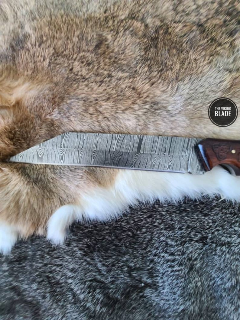 Custom Damascus steel Seax knife featuring a beautifully engraved walnut wood handle.