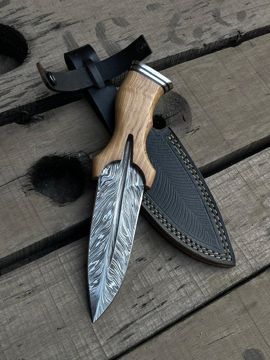 Decorative knife with wooden handle and detailed blade on a wooden surface