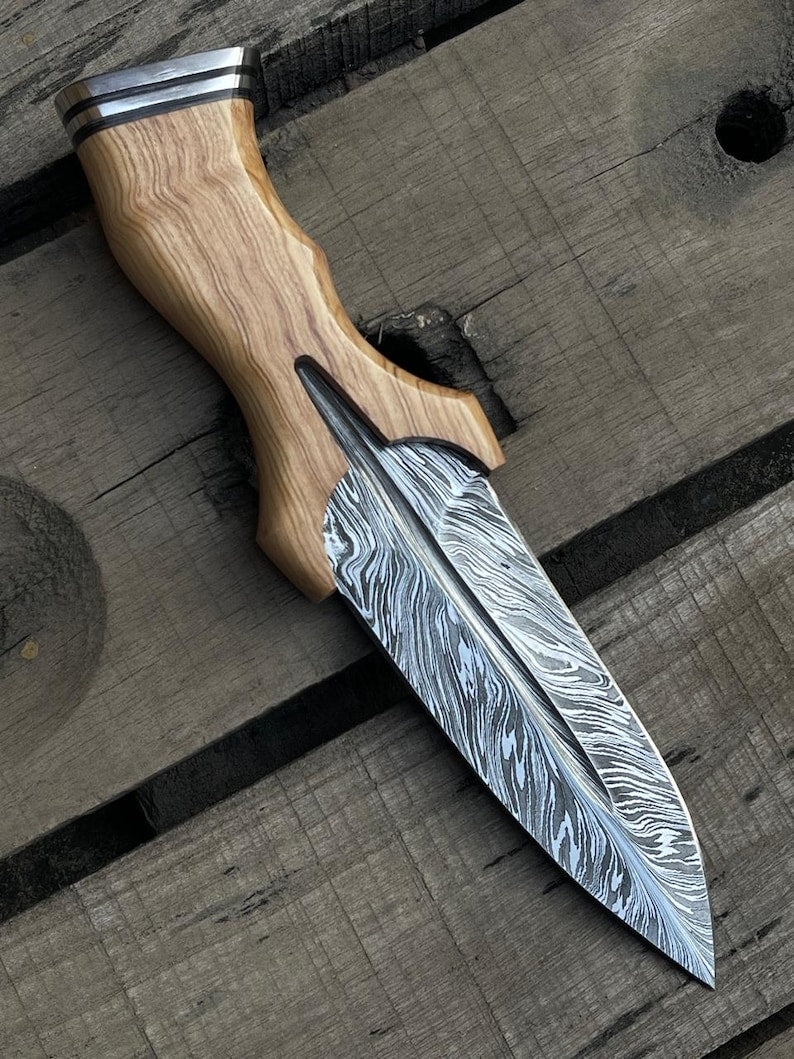 Decorative knife with wooden handle on a wooden surface