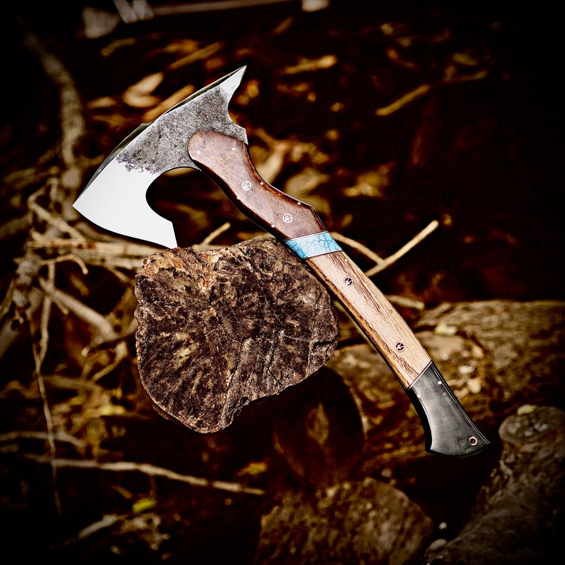 Wooden-handled axe on a log with a natural background
