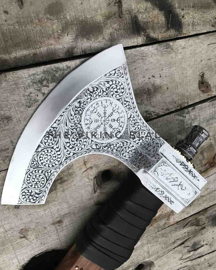 Decorative axe with intricate patterns on a wooden surface