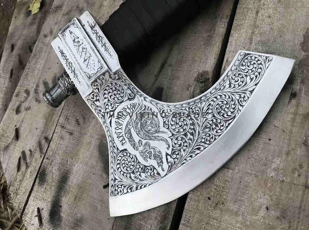 Decorative axe with intricate patterns on a wooden surface