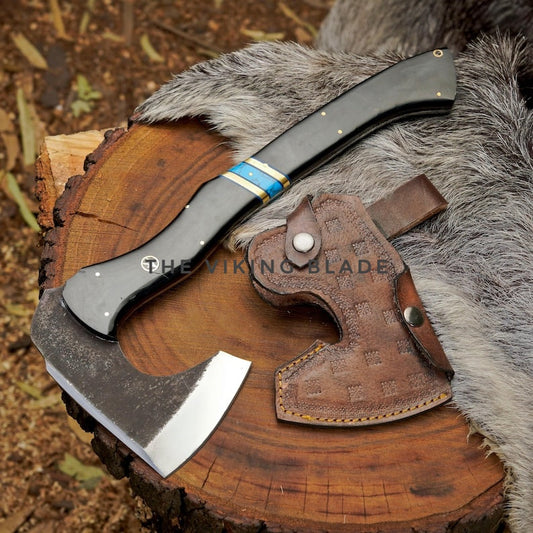 Axes with leather sheathes on a wooden surface and fur background, branded 'The Viking Blade'.