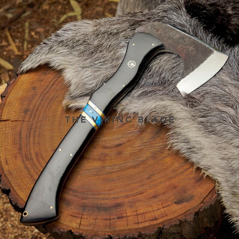 Axes with wooden handles on a wooden log and fur background, branded 'The Viking Axe'.