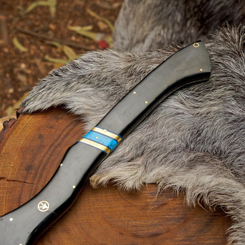 Foldable knife with decorative handle on a fur surface