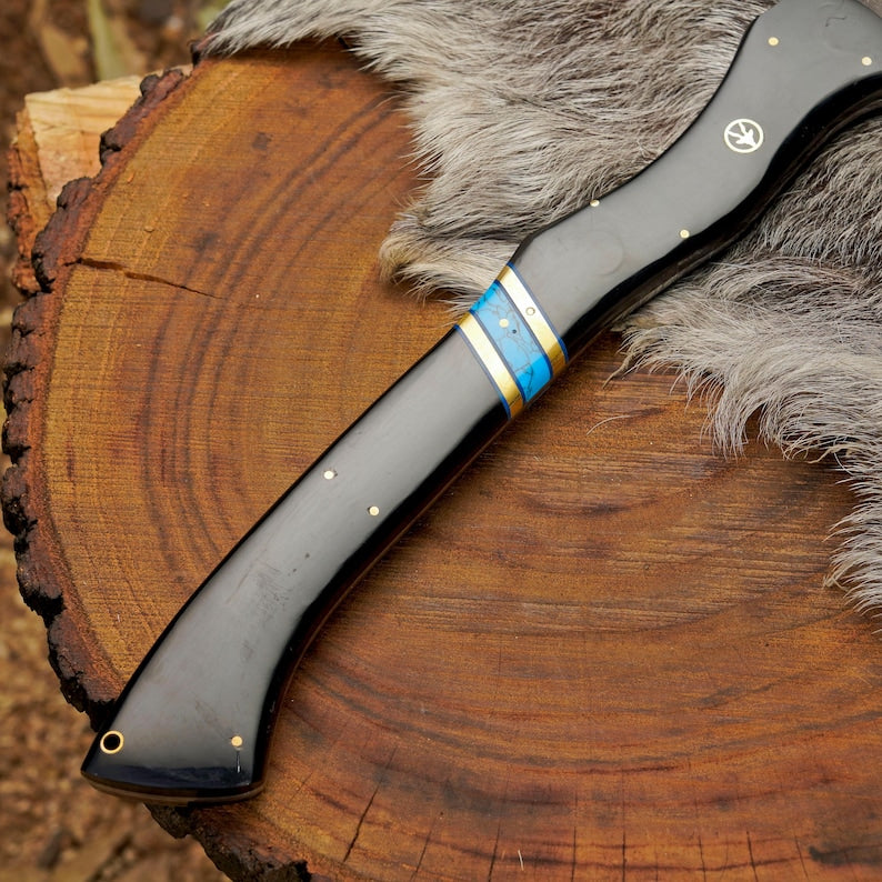 Folding knife with a decorative handle on a wooden surface