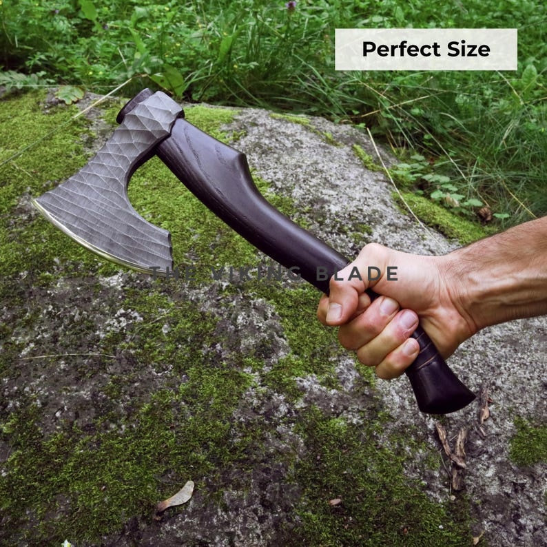 Hand holding a large axe with 'Perfect Size' text over a natural background