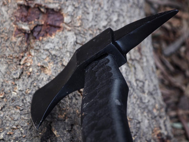 Black tool with a pointed end on a textured surface