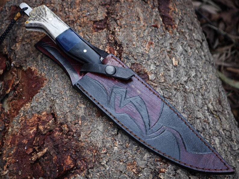 Knife with a leather sheath on a textured surface