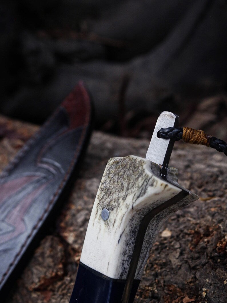 Close-up of a stone-handled axe on a textured surface