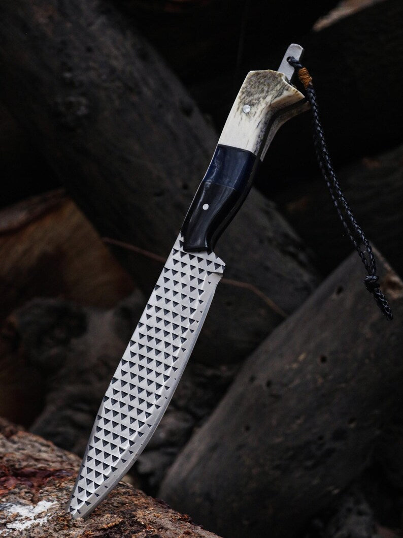 Folding knife with a unique blade design on a dark, textured background