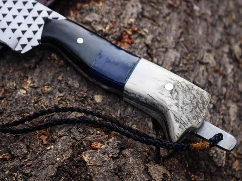 Knife with a blue and white handle on a textured surface